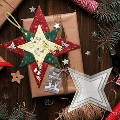 christmas presents wrapped in brown paper and decorated with stars on top of a wooden table