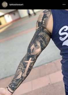 a man with a cross and angel tattoo on his arm holding onto a skateboard