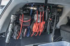 there are many items in the back of this car that is filled with gear and equipment