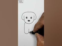 someone drawing a dog on paper with a marker