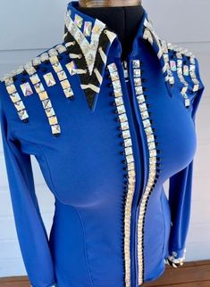 a close up of a blue shirt with sequins on the collar and sleeves