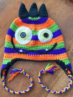 a crocheted hat with eyes and horns