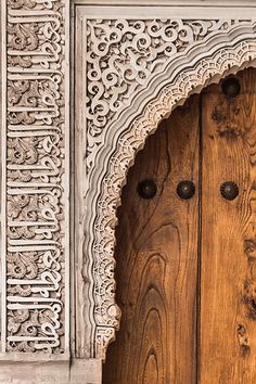 an ornate wooden door with carvings on it