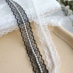 two black and white lace garters sitting on top of each other