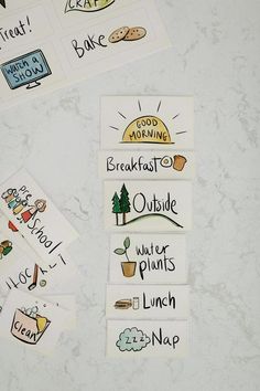 four stickers with words and pictures on them sitting on a counter top next to each other