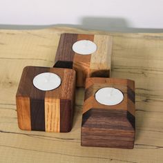 three wooden candlesticks sitting on top of a table