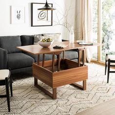 a living room with a couch, table and chairs next to a large open window