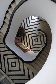 a spiral staircase with black and white designs on it