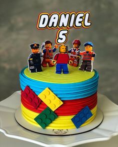 a birthday cake with legos on it and the name daniel is spelled out