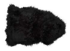 a black furry pillow sitting on top of a white floor