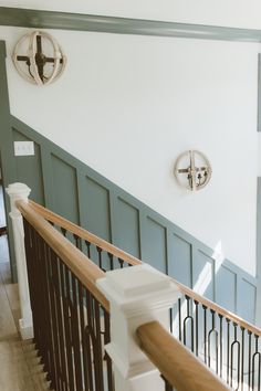 the stairs in this house have been painted white and blue with wood balconies