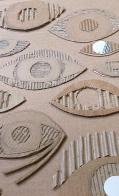 cardboard cutouts with circles and fish shapes on them are displayed in an art class