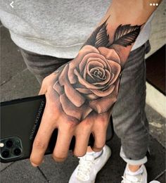 a person with a rose tattoo on their hand