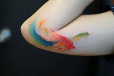 a person's arm with colorful paint on it