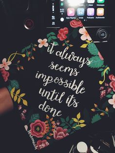 someone holding up a graduation cap that says it always seems impossible until it's done