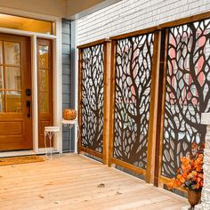 a wooden porch with an iron screen on the side and a white chair in front