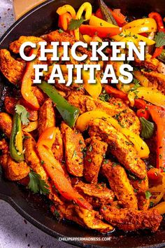 chicken fajitas with peppers and cilantro in a cast iron skillet