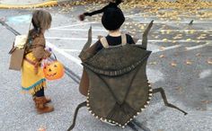 two children dressed up as bugs on the street