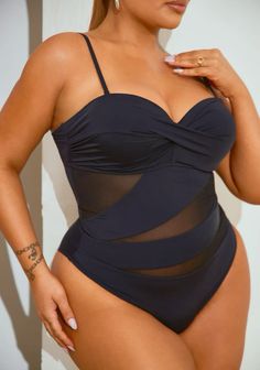 a woman in a swimsuit posing for the camera with her hand on her hip