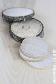 three wooden coasters sitting next to each other on a table