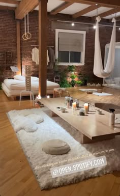 a living room filled with lots of furniture and candles on top of a wooden table