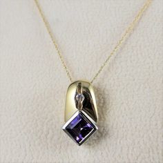 Vintage 14K solid gold amethyst and diamond pendant necklace. This great modernist design features a pendant that is comprised of both yellow and white gold. A square cut amethyst is bezel set into a diamond shape on the bottom in white gold, while the upper portion of the pendant is yellow gold with a diamond set in the center. The pendant is suspended on a very fine rope link chain. Perfect for wear daytime or evening. The pendant measures .70 inches in length by .35 inches in width. The chain Purple Necklace, Square Cut, Amethyst Purple, Diamond Pendant Necklace, Diamond Pendant, Diamond Shapes, Beautiful Necklaces, Diamond Necklace, Solid Gold