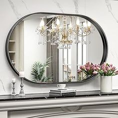 a fireplace mantel with a mirror and flowers on it