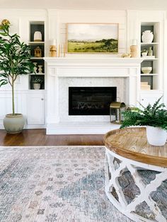 a living room filled with furniture and a fire place in front of a white fireplace