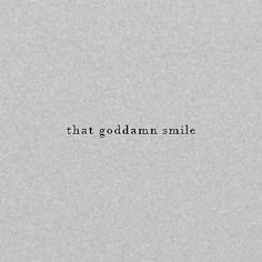 the words that godalam smile are written in black on a gray paper background