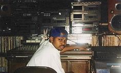 a man sitting in front of a mixing desk