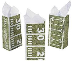 three green and white numbered paper bags with numbers on the sides, one for measuring