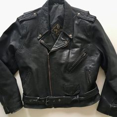 Vintage 90's black leather motorcycle jacket designed by Polarpels, NorwaySnap down collar, lapels and shoulder epaulets Traditional zippered sleeve cuffs Attached half belt with heavyweight nickel plated square buckle Three outside zippered pockets plus small functional coin flap pocketOne interior pocket Fixed nylon insulated liningJacket exterior is in great condition with minimal wear (one snap on left collar broken)Jacket interior is in great conditionLabels are intactName on label - Maxin Long Sleeve Biker Jacket With Belt Loops, Winter Biker Jacket With Belt Loops, Winter Moto Biker Jacket With Belt Loops, Moto Biker Jacket With Belt Loops For Winter, Black Moto Outerwear With Belt Loops, Black Moto Leather Jacket With Belt Loops, Biker Jacket With Belt Loops For Biker Events, Classic Black Biker Jacket With Belt Loops, Fitted Moto Biker Jacket With Belt Loops