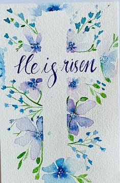 a card with watercolor flowers and the words ne is risen