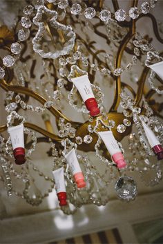 a chandelier with many different types of lip products hanging from it's sides