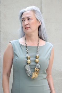 The Mya Lambrecht Trio Necklace will give you the air of confidence! Material: Metal, brassOrigin: Made in Minnesota Designer pieces Crystal beads Assorted mixed metal chain Antique brass trade beads from Nepal Handmade 31" long Mya Lambrecht incorporates everyday objects into her pieces that are seemingly out of place Fusion Style Gold Necklace With Oxidized Finish, Gold Fusion Necklace With Oxidized Finish, Artisan Gold Jewelry With Beaded Chain, Artisan Gold Necklace With Beaded Chain, Gold Oxidized Finish Long Necklace, Long Gold Necklace With Oxidized Finish, Artisan Gold Beaded Brass Necklace, Gold Necklace With Oxidized Finish, Brass Beaded Necklaces For Jewelry Making