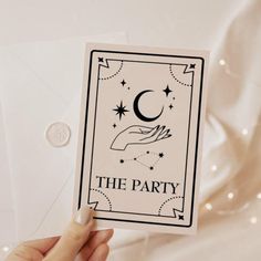 a person holding up a card with the word, the party on it and a crescent