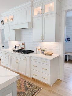 the kitchen is clean and ready for us to use it's white cabinets, counter tops, and drawers