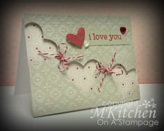 a card with two hearts on it and the words i love you written in red