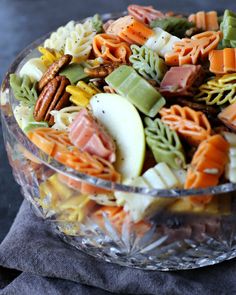 a glass bowl filled with lots of different types of food