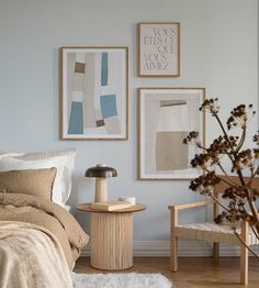 a bed room with a neatly made bed and two pictures on the wall above it