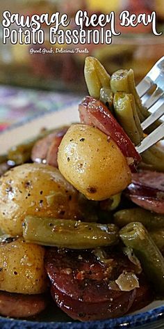 sausage and green bean potato casserole on a plate with a fork in it