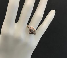 a hand with a ring on it that is sitting on a white mannequin