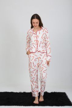 🎄 Embrace Holiday Cheer with Our Candy Cane Pajama Set! 🎄 Transform your festive mornings into cozy moments with our delightful Candy Cane Christmas Pajama Set! This charming two-piece set features a modern design adorned with playful red and white candy canes on a crisp white background, making it the perfect addition to your holiday wardrobe. ✨ Key Features: *Festive Pattern: Vibrant candy cane design that captures the spirit of Christmas. *Comfortable Fit: Long-sleeve button-up top with a c Stylish Loungewear, Adult Pajamas, Christmas Pajama Set, Cozy Moments, White Candy, Red Candy, Holiday Wardrobe, Matching Pants, Candy Canes