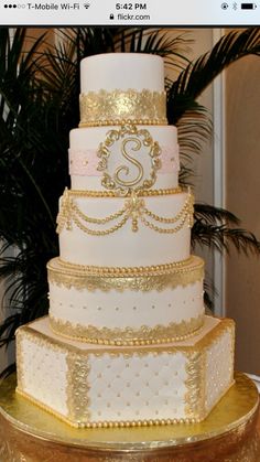 a three tiered wedding cake sitting on top of a table