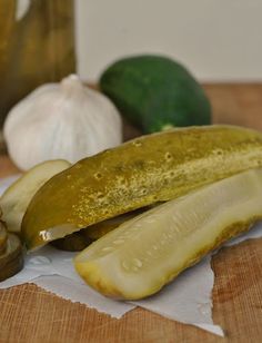 a banana and some garlic on a cutting board next to an onion, pepper, and lime