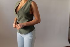 Perfect sage green sleeveless v-neck designer vest by Versace, featuring tortoise buttons down the front with a belt along the back for a tight fit. One side is a cotton like green and the other side is a silky satin. ✂----- [m e a s u r e m e n t s] Unisex Vest: Best fits a size Medium, can also fit XS - M. Flat Measures Approx. 24 in Length x 19.5 in Underarm to Underarm x 13 in Shoulder to Shoulder x Sleeveless x Yoke 3.5 in x Waist 19 in (Brand: Versace x Fabric: Feels like Cotton [i n f o] Fitted Vintage V-neck Vest, Green Buttoned Vest For Workwear, Fitted Green Vest With Button Closure, Chic Green V-neck Vest, Green Fitted Tank Top For Work, Vintage Workwear Vest Top, Vintage Vest Top For Work, Vintage Summer Vest For Workwear, Fitted Green V-neck Vest