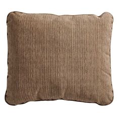 a brown pillow sitting on top of a white wall