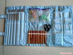 a blue case with scissors and other sewing supplies