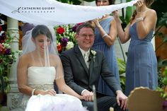 the bride and groom are sitting down for their wedding ceremony