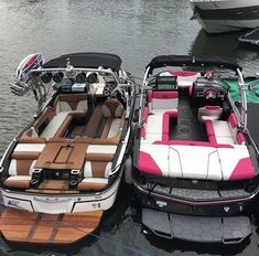 three boats are parked in the water near each other